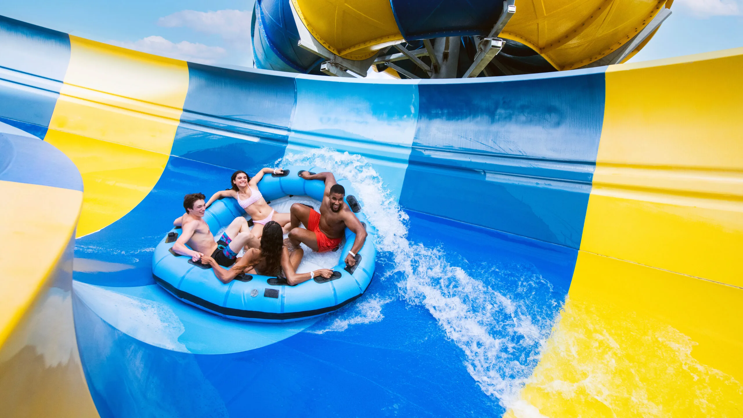 Guests riding a blue raft through a Typhoon Texas water slide