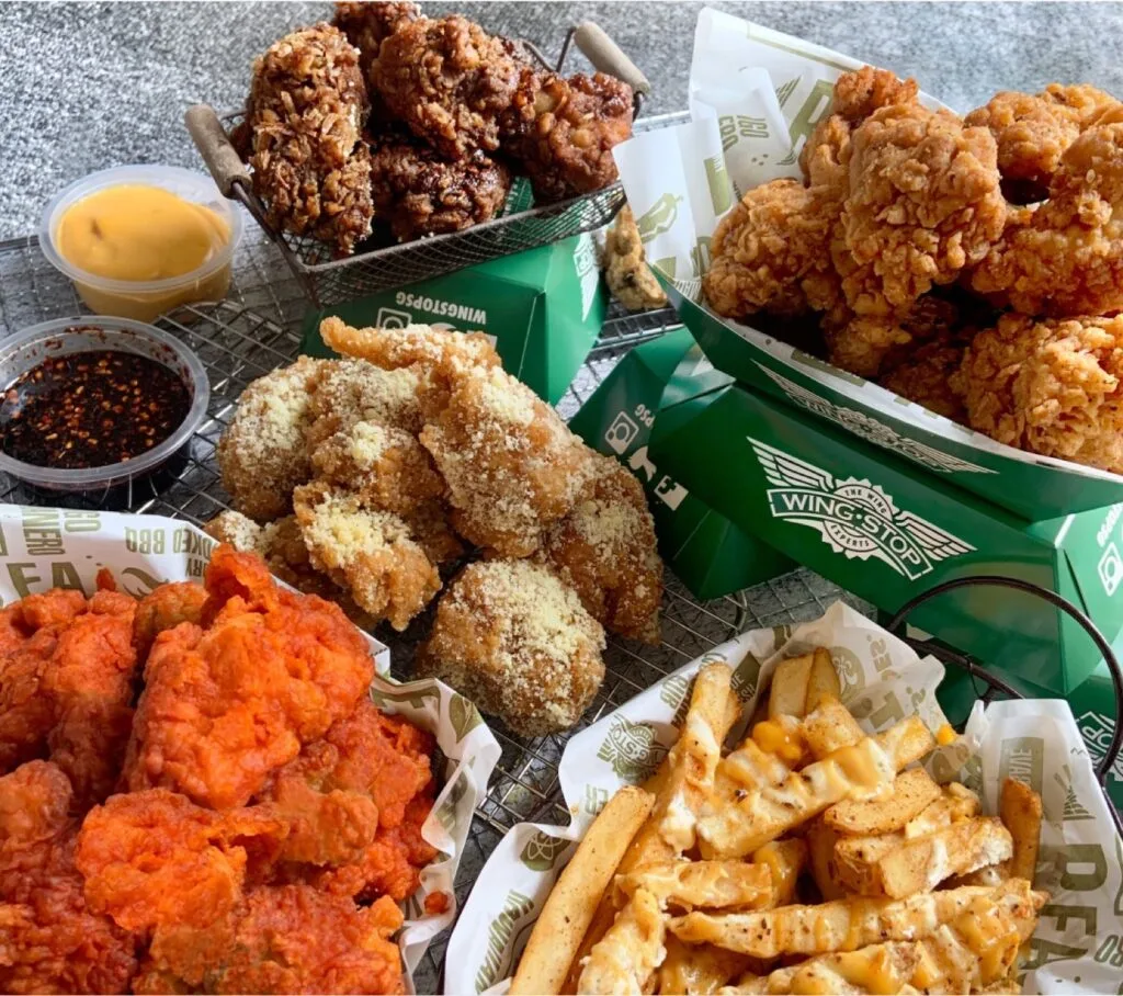 Assortment of Wingstop wings, fries, and sauces